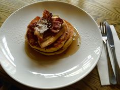 a plate topped with pancakes covered in syrup