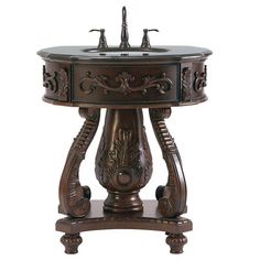 an ornate pedestal sink with two faucets on it