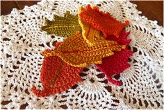 crocheted autumn leaves on a doily