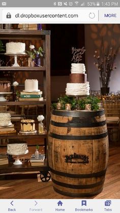 a wooden barrel sitting on top of a hard wood floor next to a table filled with cakes