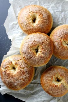 four donuts sitting on top of a piece of wax paper