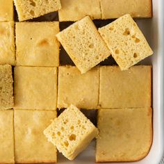 several pieces of cake sitting on top of a white tray with squares cut into them