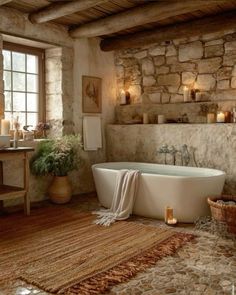 a bathroom with stone walls and flooring has a large bathtub in the center