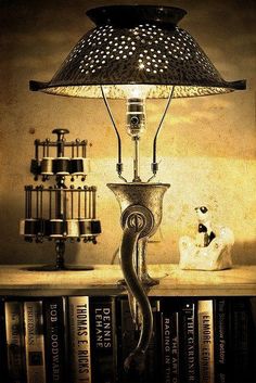 a lamp sitting on top of a table next to books