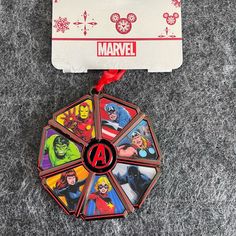 the avengers christmas ornament has been placed on top of a card holder with red ribbon