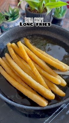 some french fries are in a frying pan