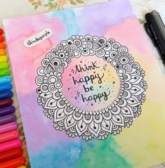 a colorful notebook with the words think happy be happy written on it next to crayons