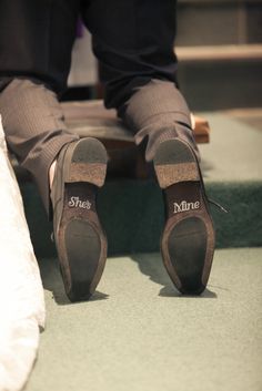 a person's feet wearing shoes with the word mine written on them