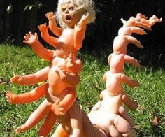 two dolls are playing in the grass with fake carrots on their heads and arms