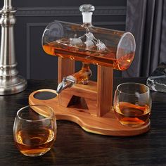 two glasses and a decanter on a table