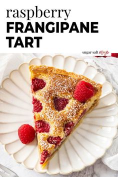 a white plate topped with a slice of raspberry franigiane tart