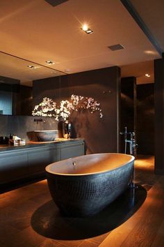 a large bath tub sitting in the middle of a bathroom next to a counter top