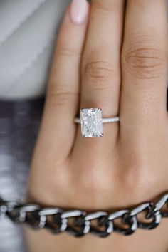 a woman's hand with a diamond ring on it