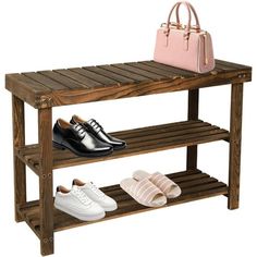 two pairs of shoes and a handbag on a wooden shelf next to a purse