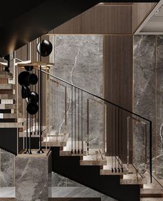 an elegant staircase with marble walls and black balconies