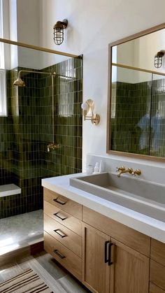 a bathroom with two sinks and a large mirror