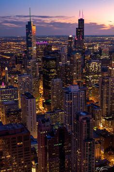 an aerial view of the city at night with skyscrapers and apple logo on it