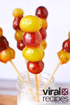 several gummy bears on sticks in a glass jar