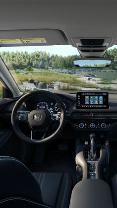 the interior of a car with dashboard, steering wheel and dash board showing on screen