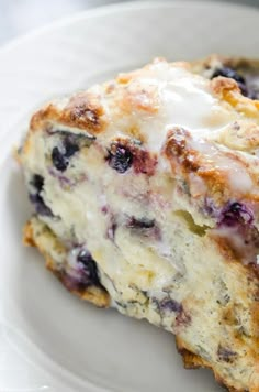 a piece of blueberry cheesecake on a white plate