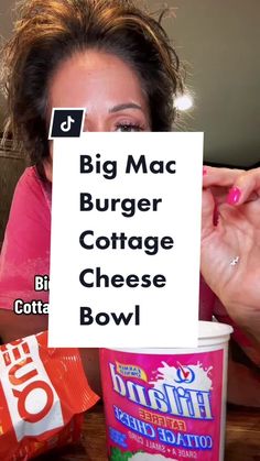 a woman holding up a sign with the words big mac burger cottage cheese bowl on it