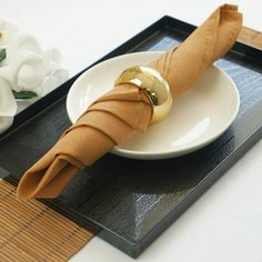 a plate with an umbrella on it next to flowers