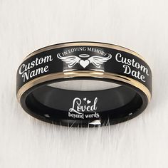 two black and gold wedding bands with the words custom name engraved on each one side