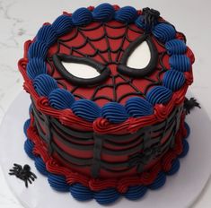 a spiderman cake with blue and red icing