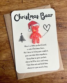 a card with a teddy bear wearing a santa claus hat on it's head