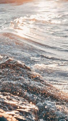 the sun shines on the water as it breaks through the waves in the ocean