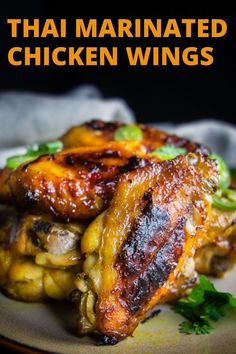 grilled chicken wings on a plate with cilantro and parsley garnish