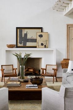 a living room filled with furniture and a fire place in front of a painting on the wall