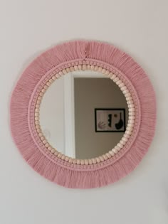 a round mirror hanging on the wall