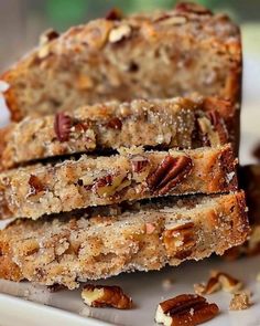 three slices of pecan bread stacked on top of each other with nuts around them