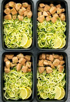 four plastic containers filled with zucchini noodles and tofu pieces on top of them