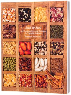 the seed to seed cookbook is shown in an old wooden box with many different types of seeds