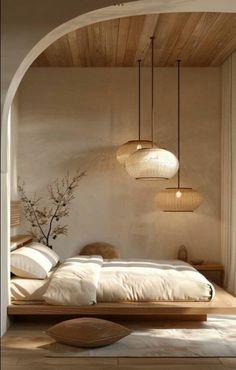 a bed room with a neatly made bed and two lamps hanging from the ceiling above it