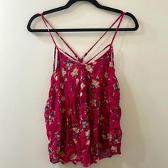 Perfect Condition, Washed But Never Worn. Aeo Red Floral Tank Top With Spaghetti Straps. Strap Design Is In The Front And Crosses In The Back. Straps Are Adjustable And The Flowing Design Is Perfect For The Summer! Size Medium 100% Viscose Red Tank Top For Spring Vacation, Red Cami Tank Top For Beach, Red Camisole Tank Top For Summer, Red Camisole With Adjustable Straps, Red V-neck Summer Tank Top, Floral Print Spaghetti Strap Top For Beach, Floral Print Top With Spaghetti Straps For Beach, Red Cami Tank Top For Summer, Red Floral Print Tank Top For Spring