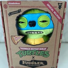 the teenage mutant ninja turtle plush toy is in its box