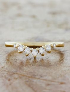 a gold ring with three diamonds on it