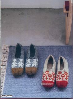 two pairs of shoes sitting on top of a blue rug next to a wooden door