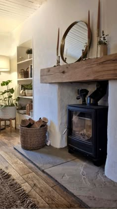 a living room with a fire place and a mirror on the wall