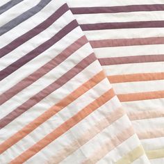 three different colored striped sheets laying on top of each other