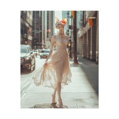 a woman is walking down the street wearing a dress and headpiece with an orange flower in her hair