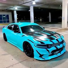 a blue and black car parked in a parking garage