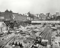 an old black and white photo of train tracks in the middle of a construction area