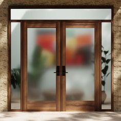 an open wooden door in front of a brick wall with potted plants on it