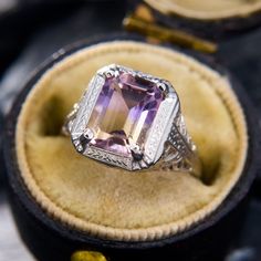 This attractive ring has an emerald cut ametrine set into an Art Deco mounting with classic filigree details. The ring is crafted in 14k white gold and is currently a size 3.25, with complimentary resizing available. Pretty Rocks, Filigree Ring, The Ring, Emerald Cut, Emerald, Jewelry Rings, Art Deco, White Gold, Ring