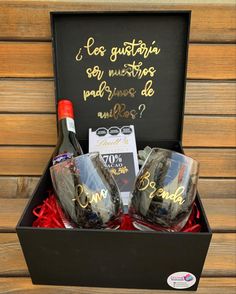 two wine glasses in a gift box with writing on it