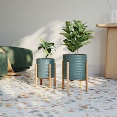 Introduce a splash of color and style into your indoor space with the Rhys Indoor Blue-Green Metal Planter Pot With Kinsley Wood Planter Base - (Small & Medium Set) - 14.75"H x 12"W. This set includes two planters that combine vibrant blue-green honeycomb textured metal pots with sturdy four-legged wood bases, perfect for any mid-century modern decor. The planter sizes, 12"H x 10"W and 14.75"H x 12"W, allow for versatility in plant selection and placement within your home. Enhance your living or Tabletop Planter, Resin Planters, Wood Planter, Garden Pottery, Plastic Planters, Green Metal, Metal Planters, Wood Planters, Mid Century Modern Decor